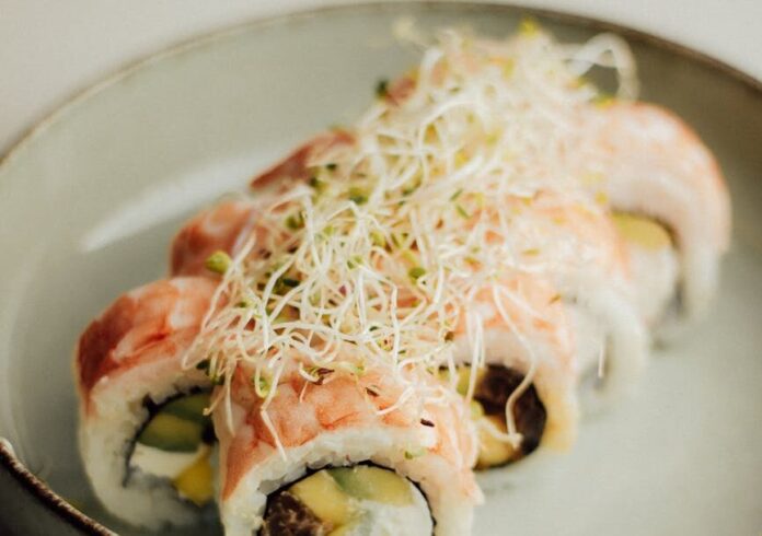 pexels-photo-34023592 delicious salmon sushi roll with sprouts