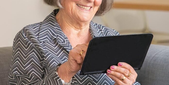 elderly woman using tablet
