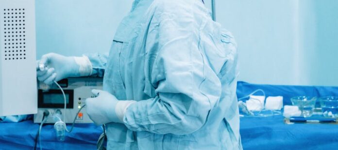 nurse preparing equipment in hospital room