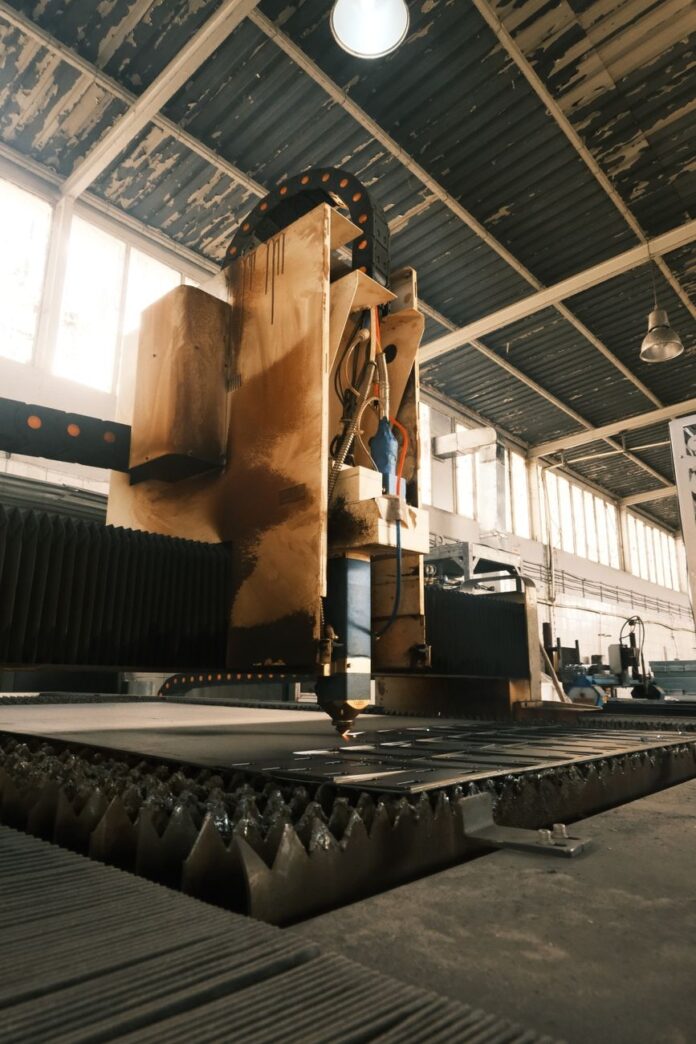 industrial laser cutter in operation inside factory