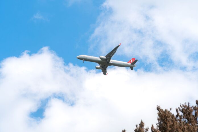 pexels-photo-37644602 commercial airplane flying in clear blue sky