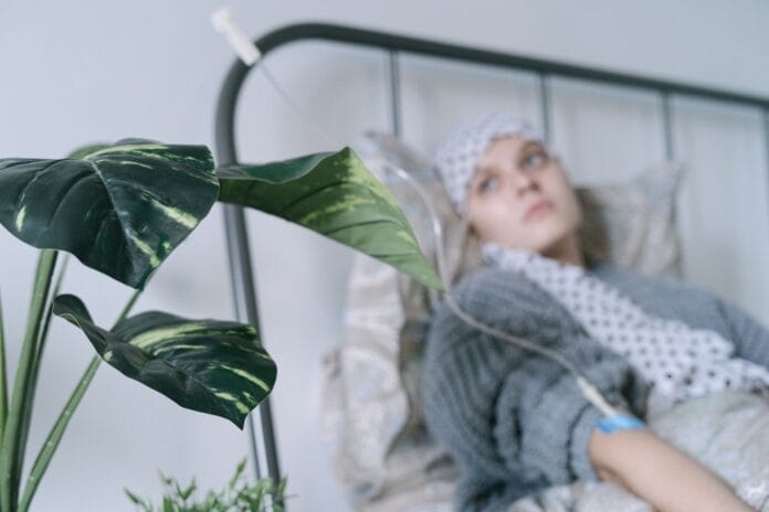 pexels-photo-6436263 a woman lying in bed while undergoing treatment
