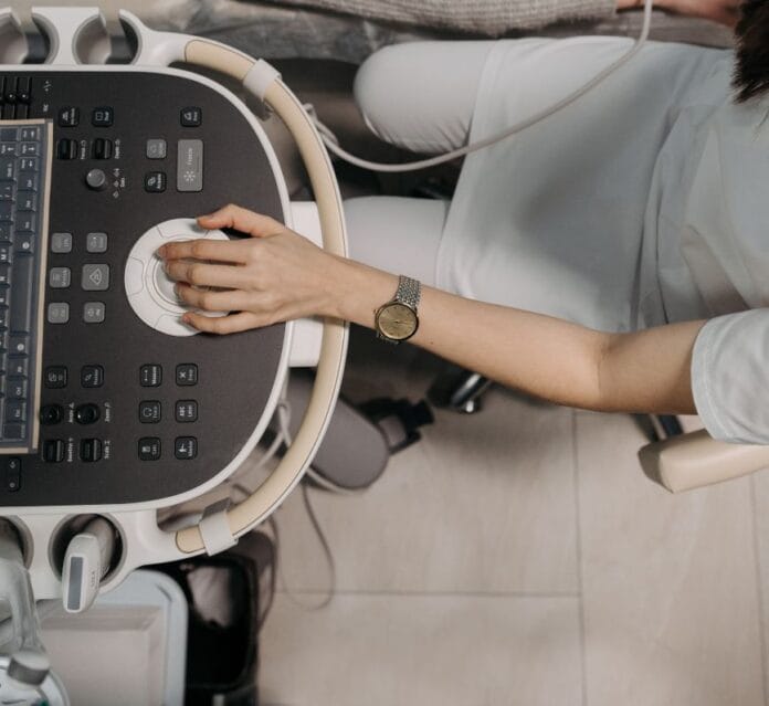 pexels-photo-7108420 woman in gray sweater doing an ultrasound