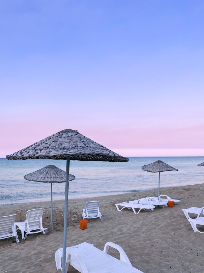 pexels-photo-14423224 sunloungers and umbrellas at a beachfront