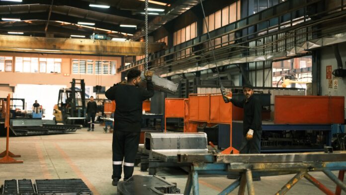 industrial workers operating machinery in factory