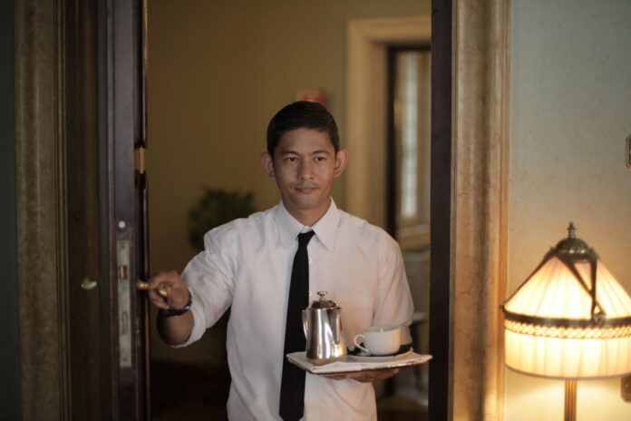hotel servant carrying coffee to guest