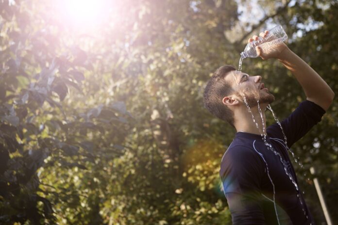 pexels-photo-3776806 man in blue crew neck t shirt while pouring water on his face