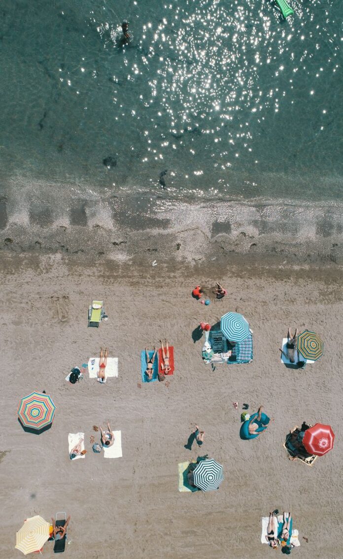 aerial shot of people sunbathing at the beach